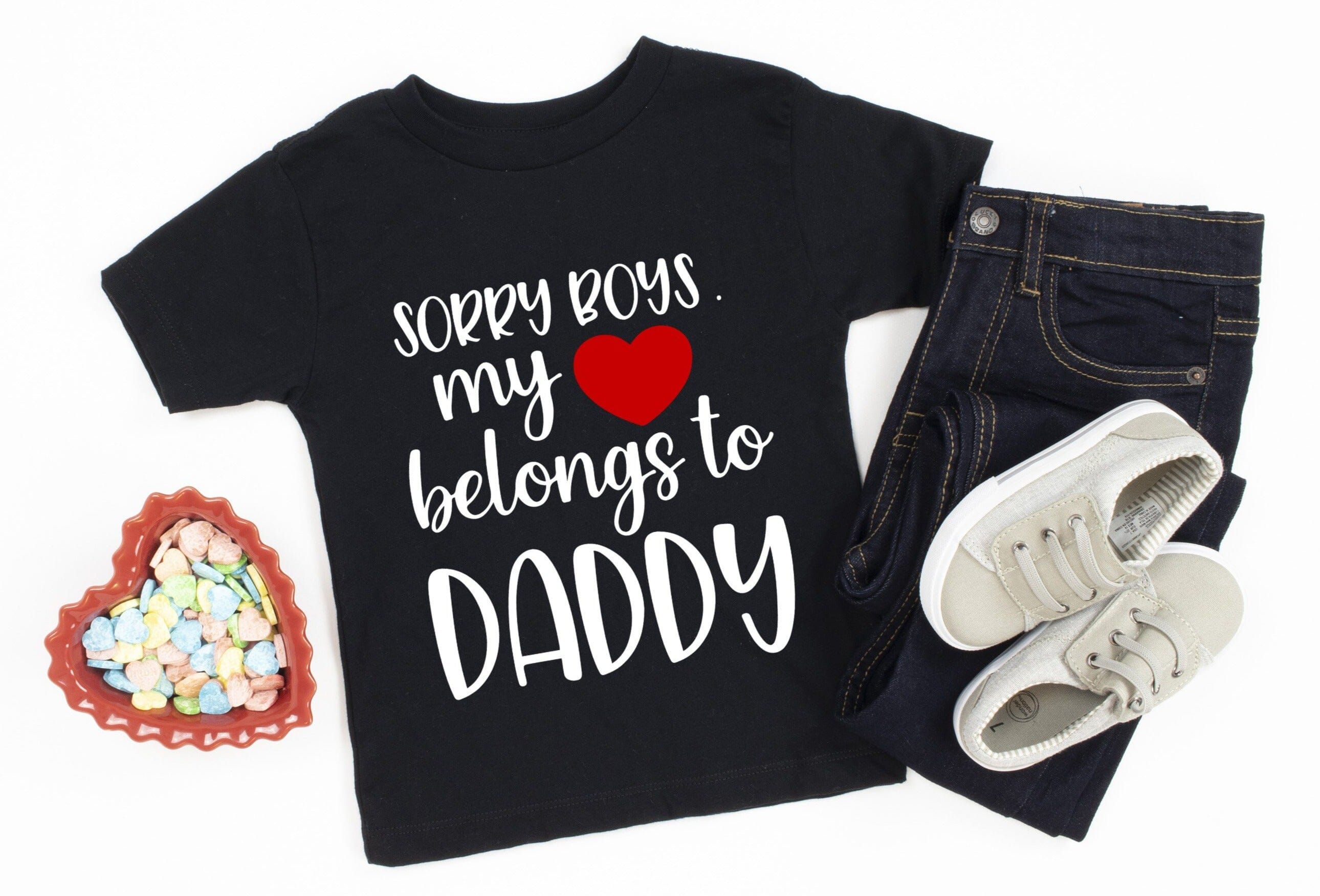 A cute toddler wearing the Heart Belongs To Daddy Tee, showcasing its playful design and comfortable fit.