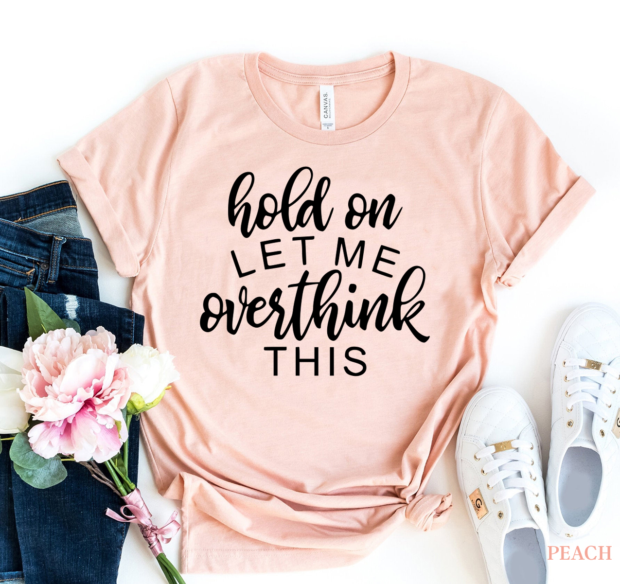 Hold On Let Me Overthink This T-shirt in premium ring spun cotton, featuring a humorous print and available in various sizes.