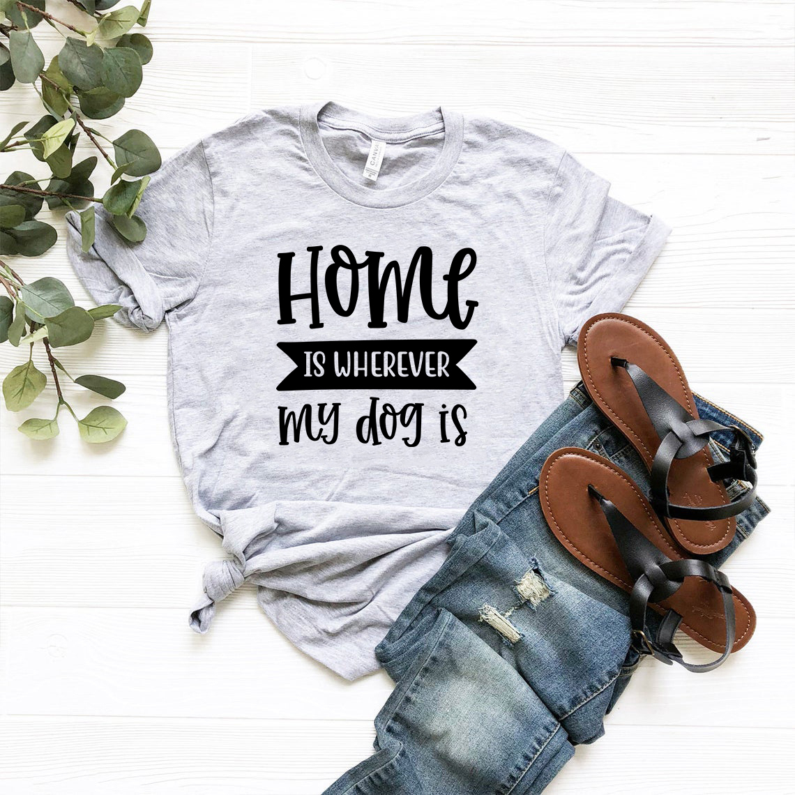 Unisex T-shirt featuring the phrase 'Home Is Where My Dogs' in a stylish design, made from soft ring spun cotton, available in multiple colors.