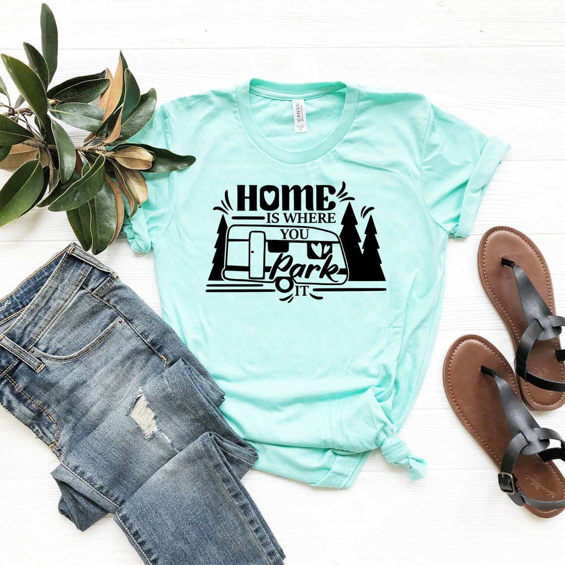 A comfortable unisex T-shirt featuring the phrase 'Home Is Where You Park It' in a stylish print, available in various colors.