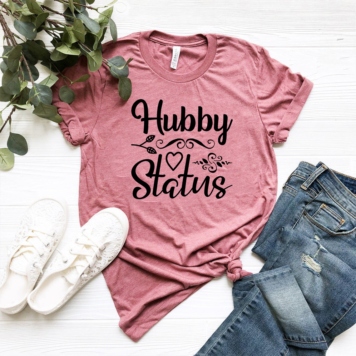 A stylish Hubby Status unisex T-shirt in various colors, showcasing its comfortable fit and high-quality print.