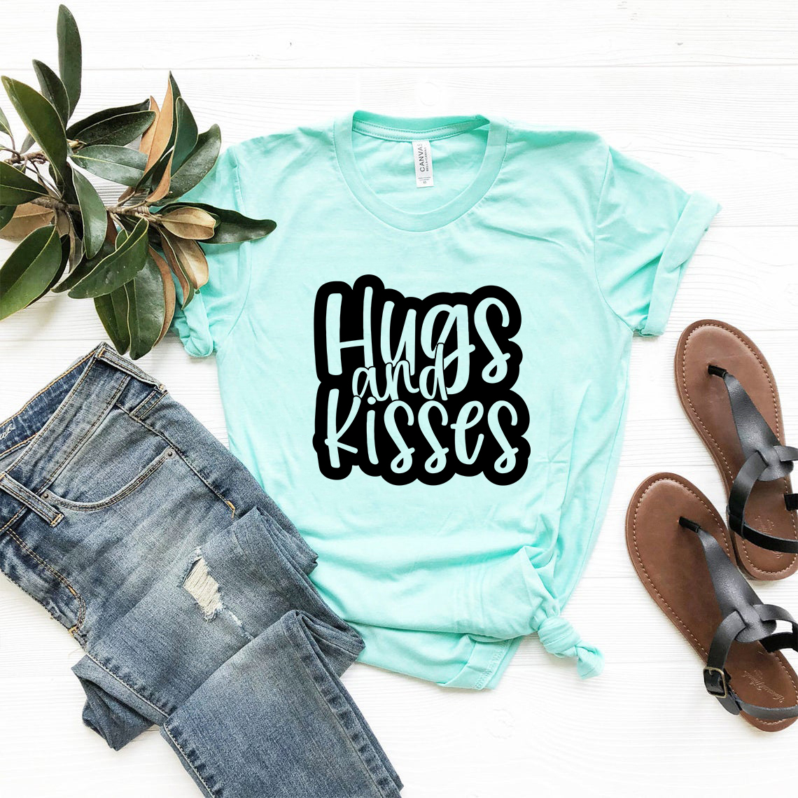 A stylish unisex Hugs And Kisses Shirt made from soft ring spun cotton, available in multiple colors.