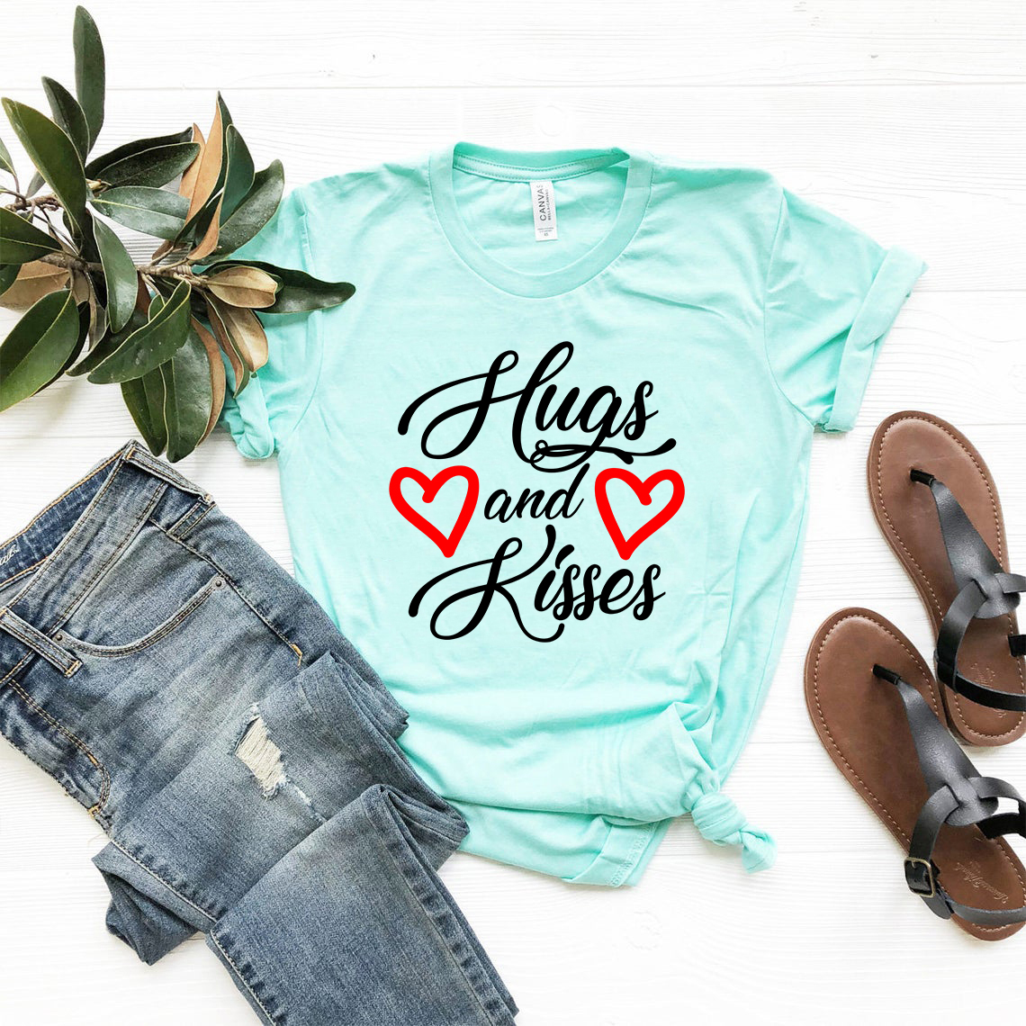 A stylish unisex Hugs And Kisses Shirt made from soft ring spun cotton, available in multiple colors and sizes.