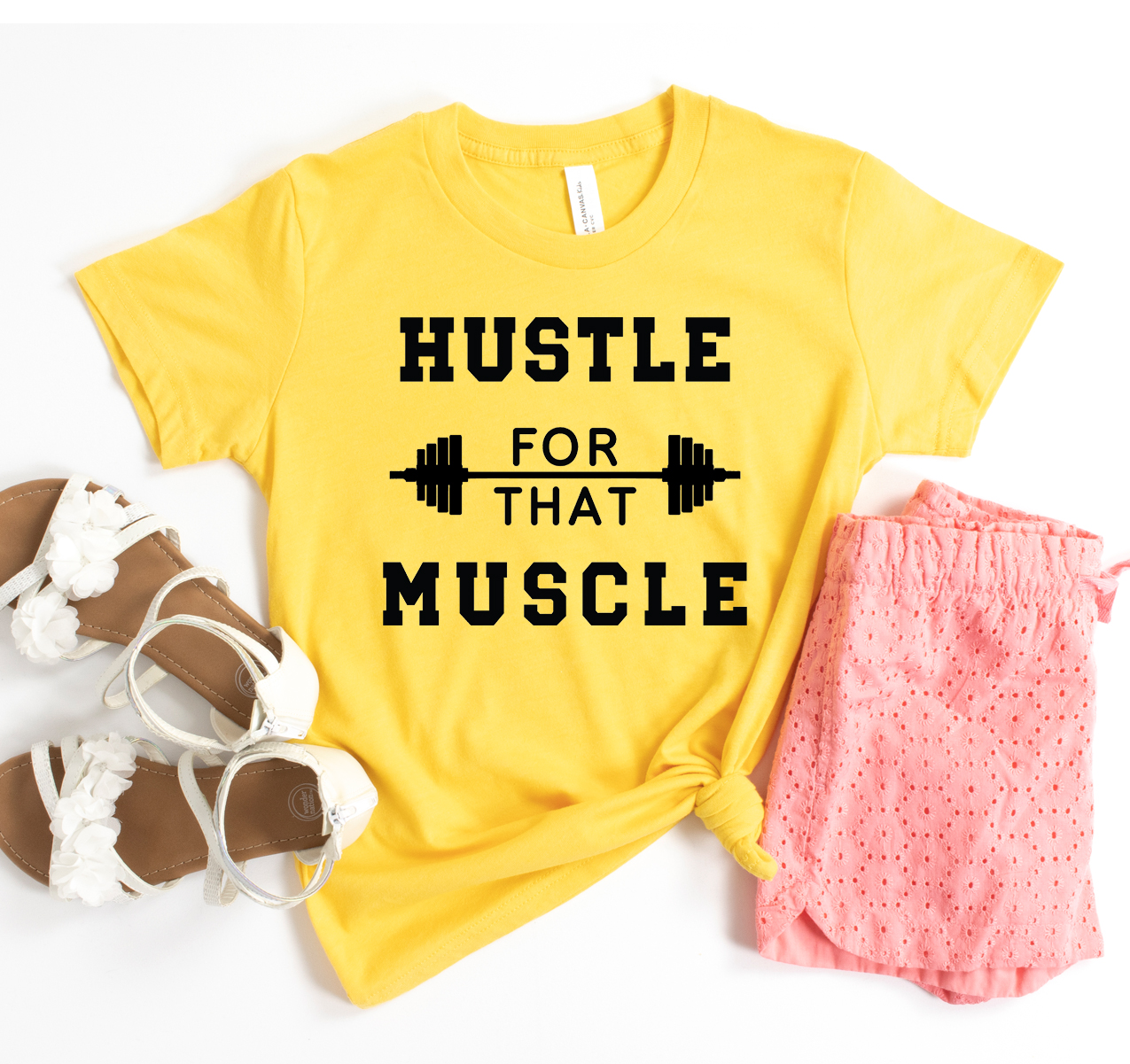 Hustle For The Muscle T-shirt in various sizes, showcasing its soft fabric and unisex design.