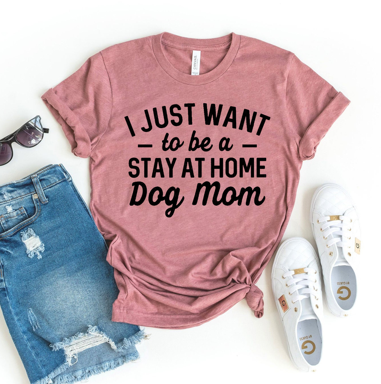 A stylish T-shirt featuring the phrase 'I Just Want To Be A Stay At Home Dog Mom', made from soft ring spun cotton, perfect for dog lovers.