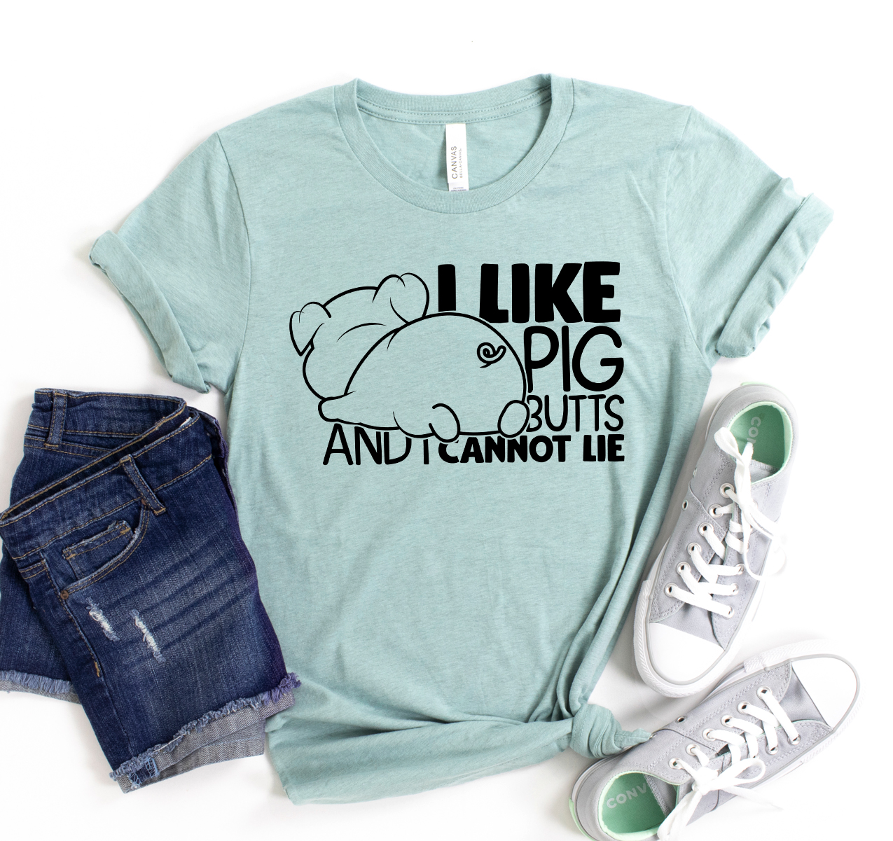 A humorous unisex t-shirt featuring the phrase 'I Like Pig Butts And I Cannot Lie' in bold letters, made from soft cotton fabric.