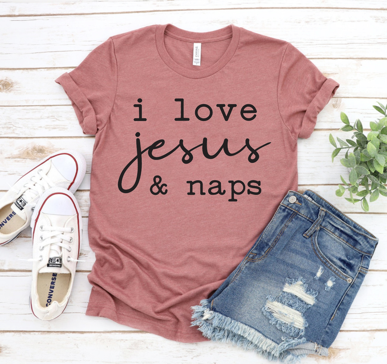 A comfortable unisex T-shirt featuring the phrase 'I Love Jesus And Naps' in a stylish font.