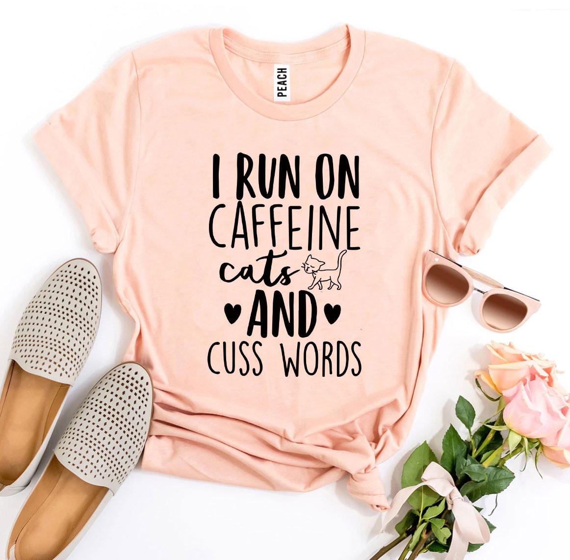 I Run On Caffeine Cats And Cuss Words T-shirt displayed on a mannequin, showcasing its soft fabric and vibrant print.