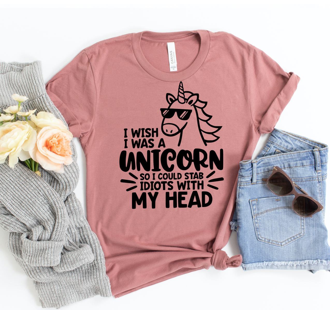 A humorous unisex t-shirt featuring a unicorn design with the phrase 'I Wish I Was Unicorn So I Could Stab Idiots With My Head'.