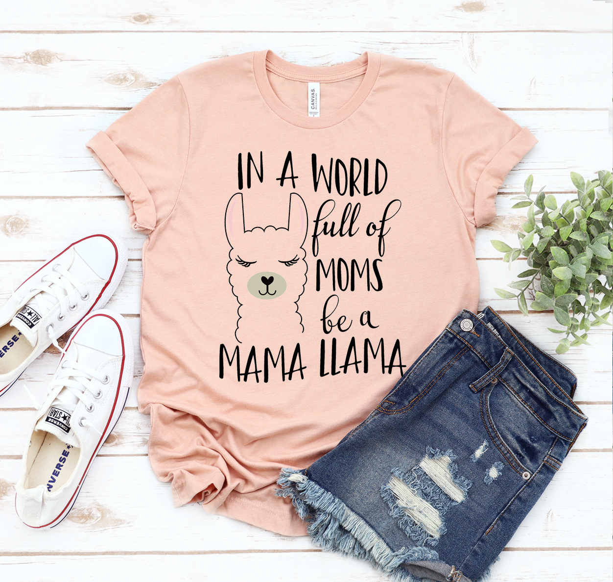 A stylish unisex t-shirt featuring the phrase 'In A World Full Of Moms Be a Mama Llama' in playful typography.