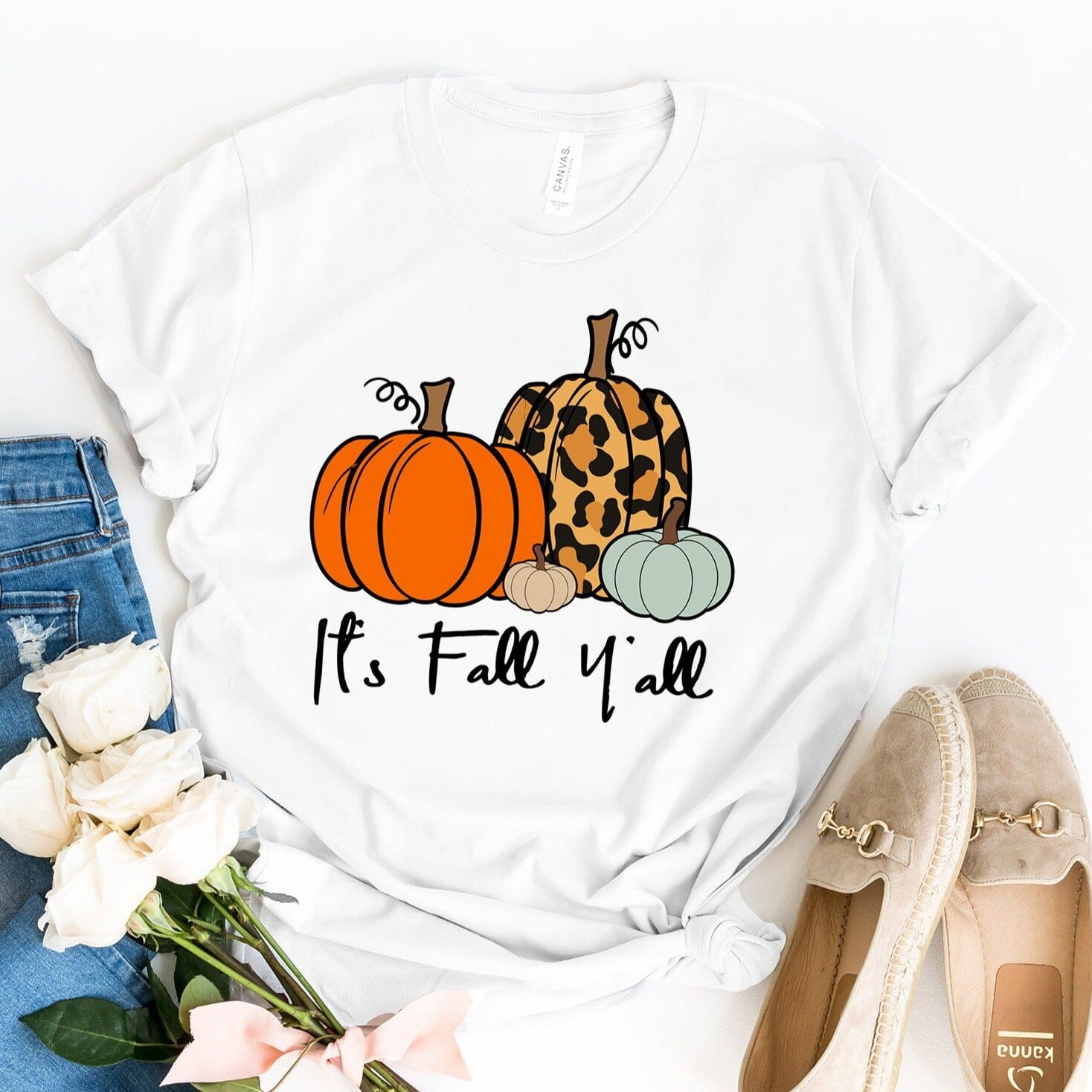 A stylish It's Fall Y'all Tee in a cozy autumn setting, showcasing its comfortable fabric and modern fit.