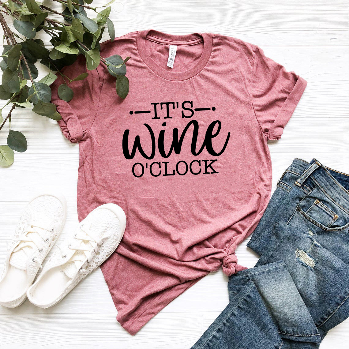 A stylish unisex T-shirt featuring the phrase 'Its Wine O'clock' in vibrant print, made from soft ring spun cotton, available in multiple colors.