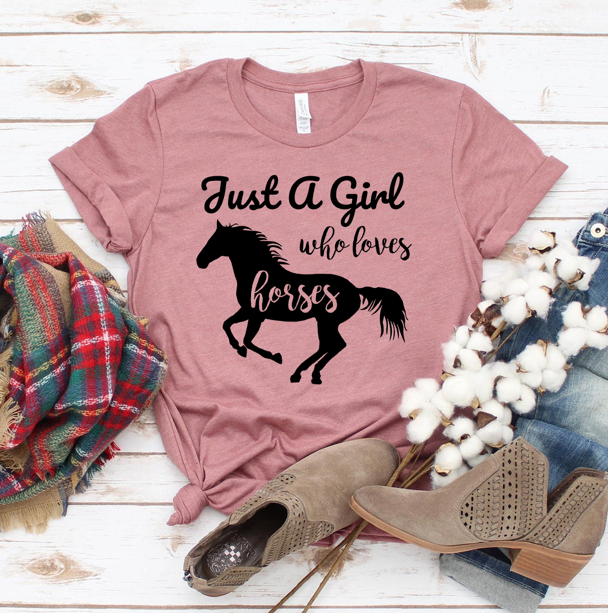 A stylish t-shirt featuring the phrase 'Just A Girl Who Loves Horses', made from premium ring spun cotton with a soft feel.