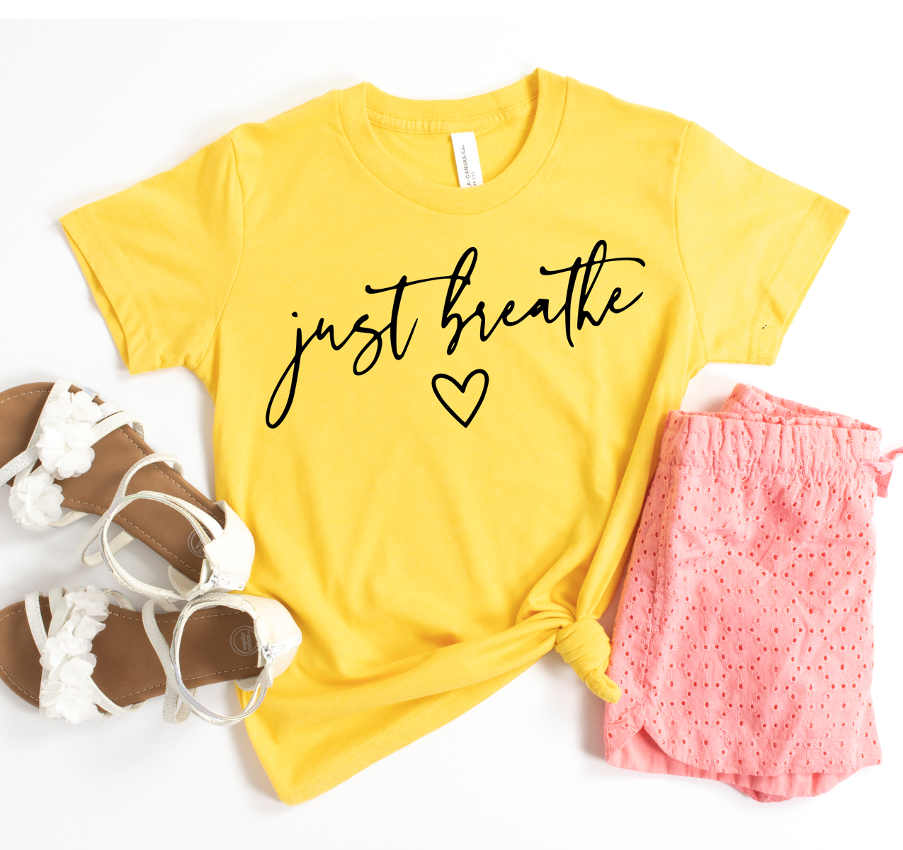 Just Breathe T-shirt in various colors, showcasing its unisex design and soft fabric.