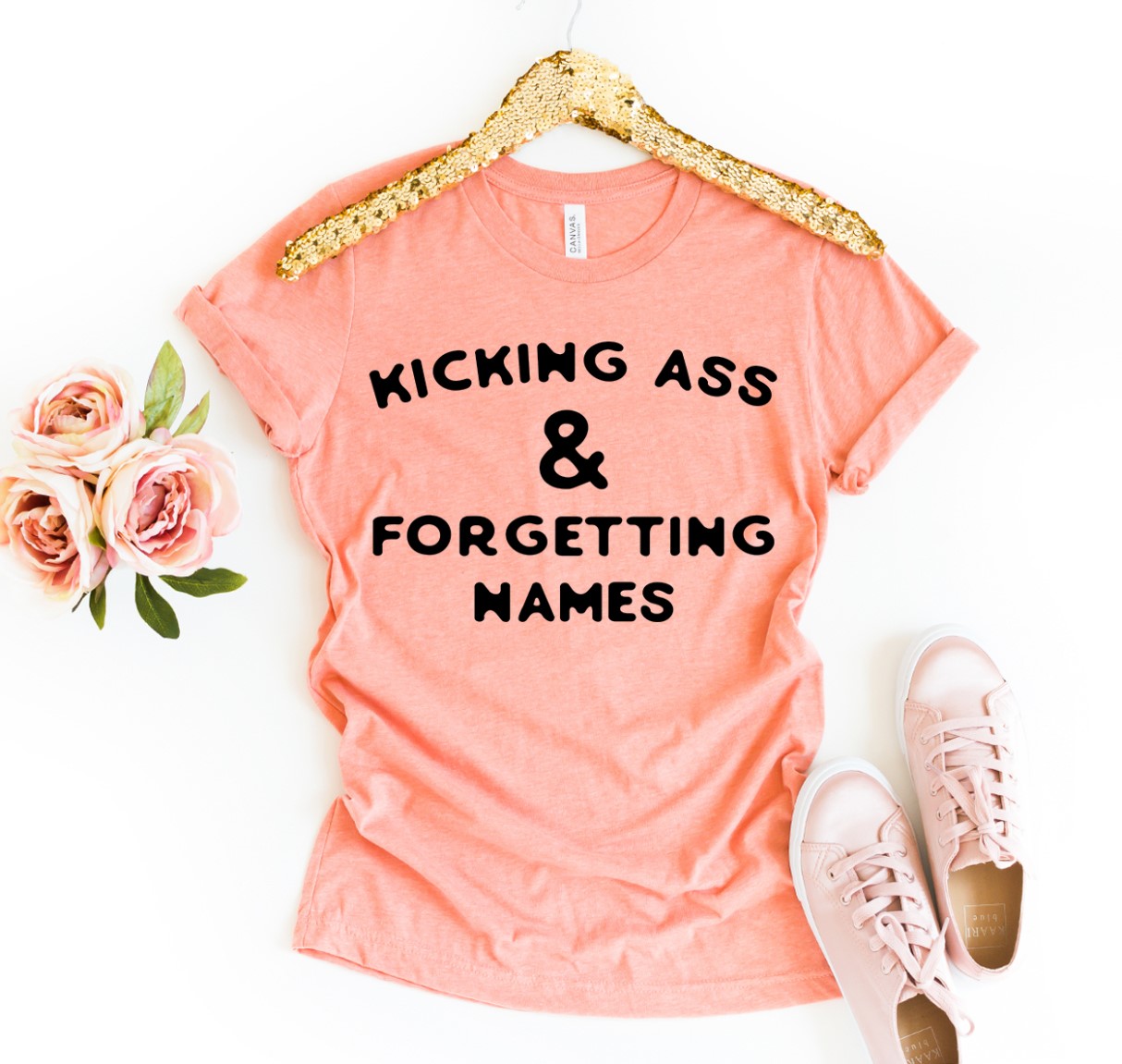 Kicking Ass & Forgetting Names T-shirt in various sizes, showcasing its premium quality cotton and vibrant print design.