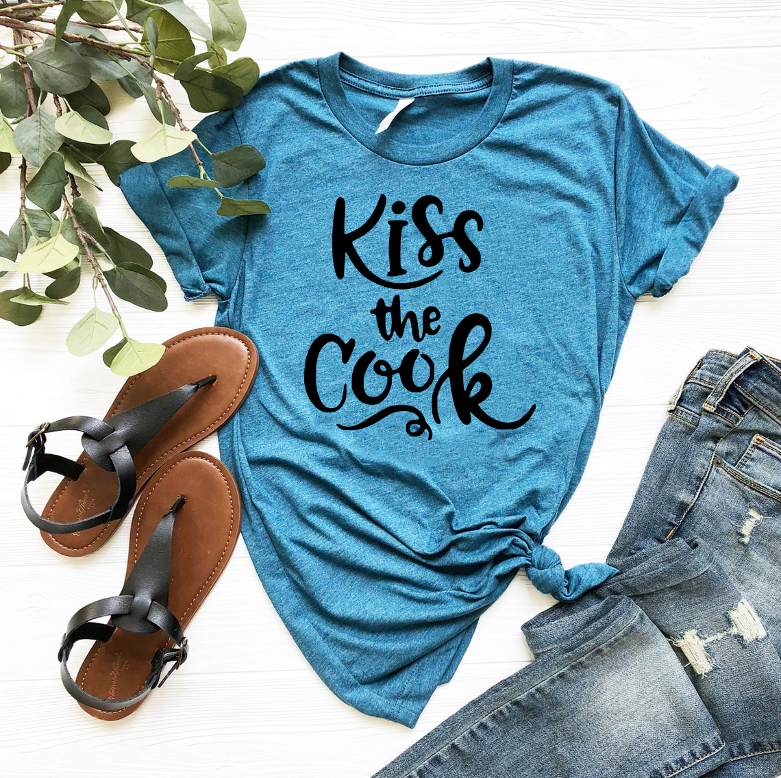 Kiss The Cook Shirt in various colors, showcasing its comfortable fit and stylish design, perfect for cooking enthusiasts.