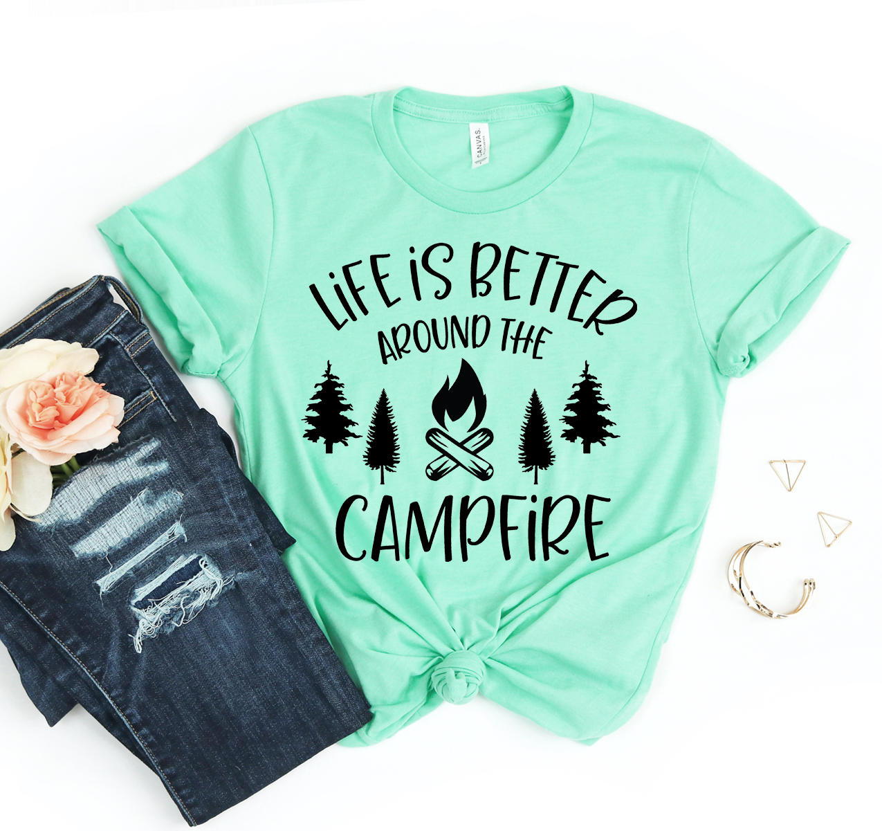 A unisex T-shirt featuring the phrase 'Life is Better Around the Campfire' in a stylish font, made from soft cotton fabric.