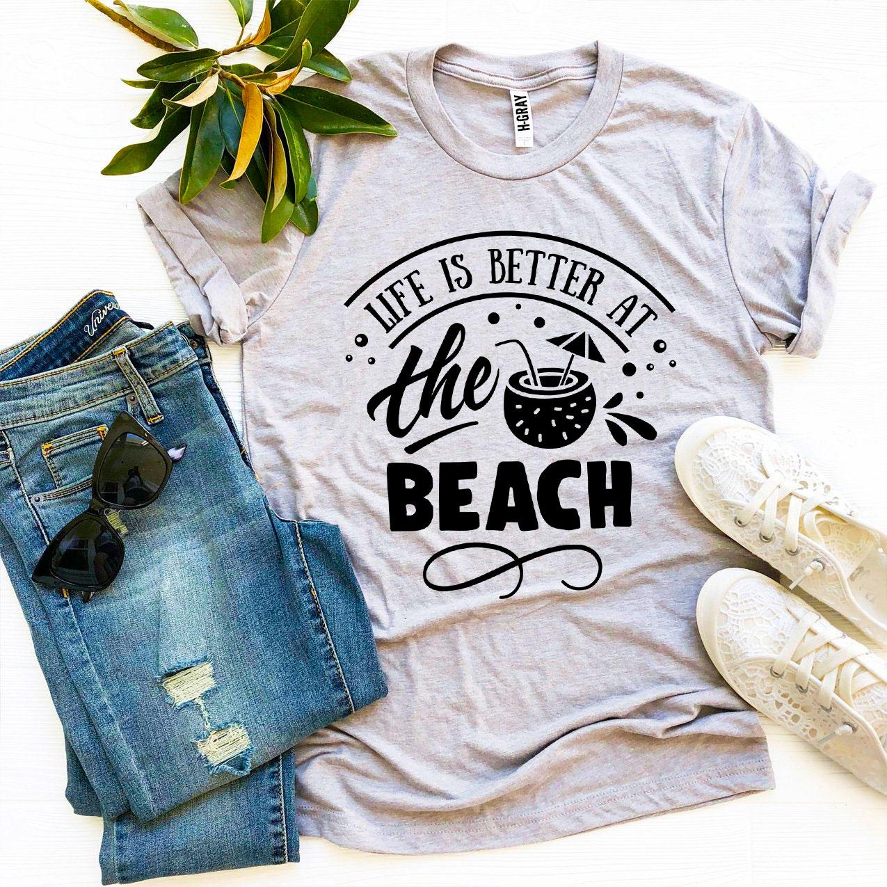 A stylish 'Life Is Better At The Beach' T-shirt made from premium ring spun cotton, featuring a vibrant flex print design.