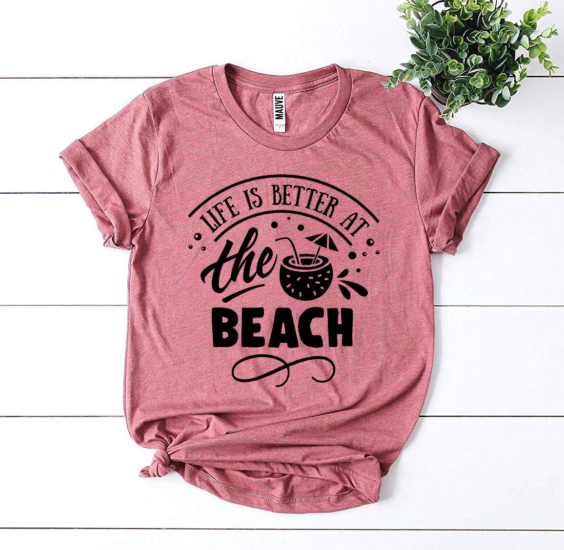 A stylish 'Life Is Better At The Beach' T-shirt made from premium ring spun cotton, featuring a vibrant flex print design.