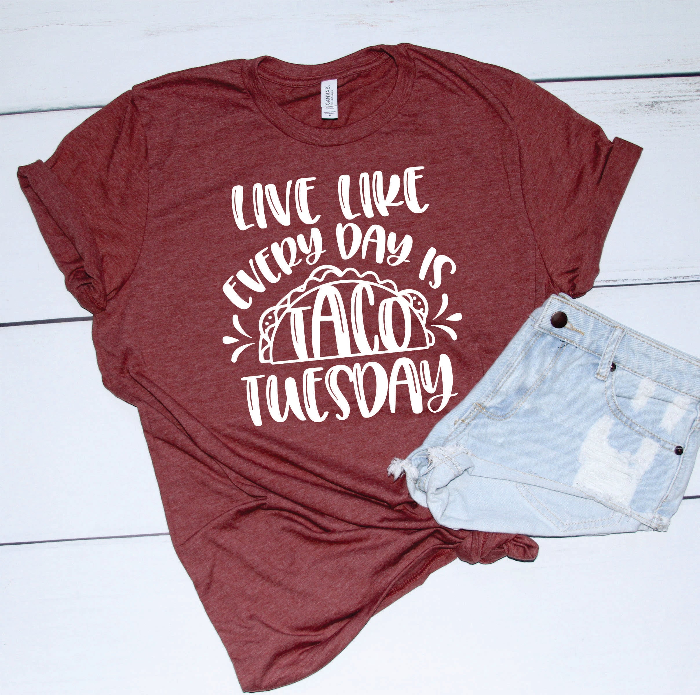 A unisex graphic tee featuring a colorful taco design with the phrase 'LIVE LIKE EVERYDAY IS TACO TUESDAY'.