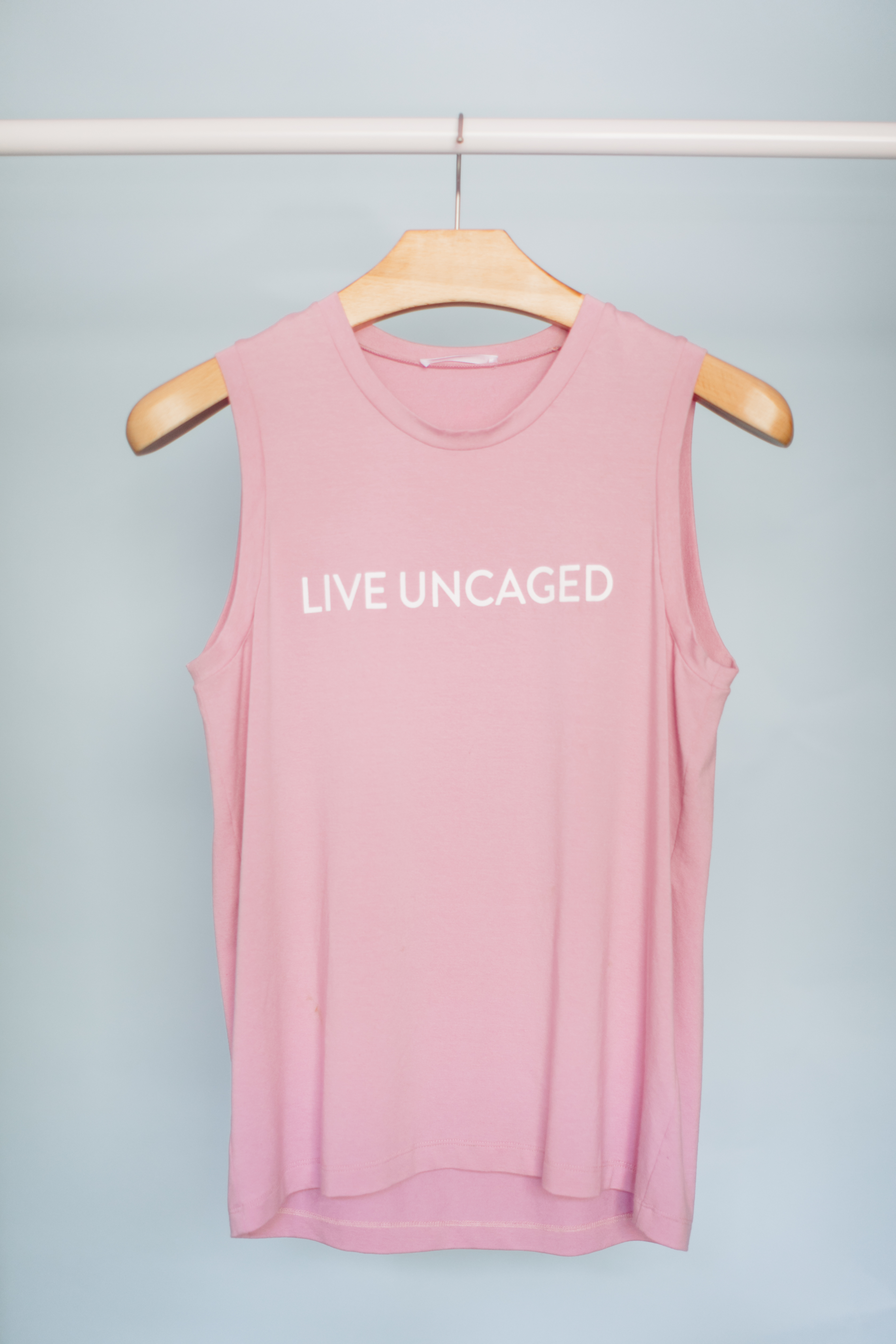 LIVE UNCAGED Tank in Spiced Coral, showcasing its relaxed fit and soft fabric, perfect for casual or office wear.