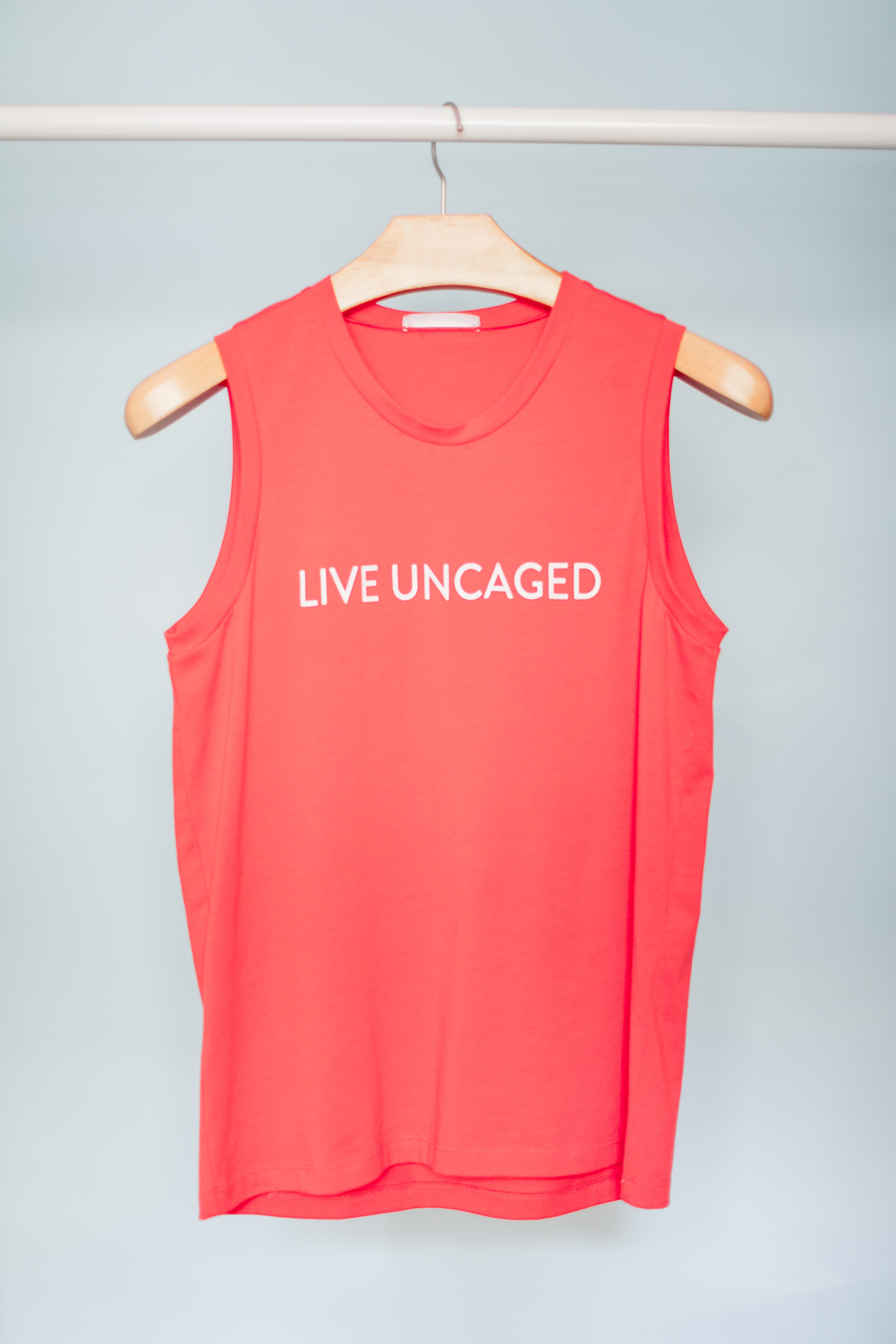 LIVE UNCAGED Tank in Spiced Coral, showcasing its relaxed fit and soft fabric, perfect for casual or office wear.