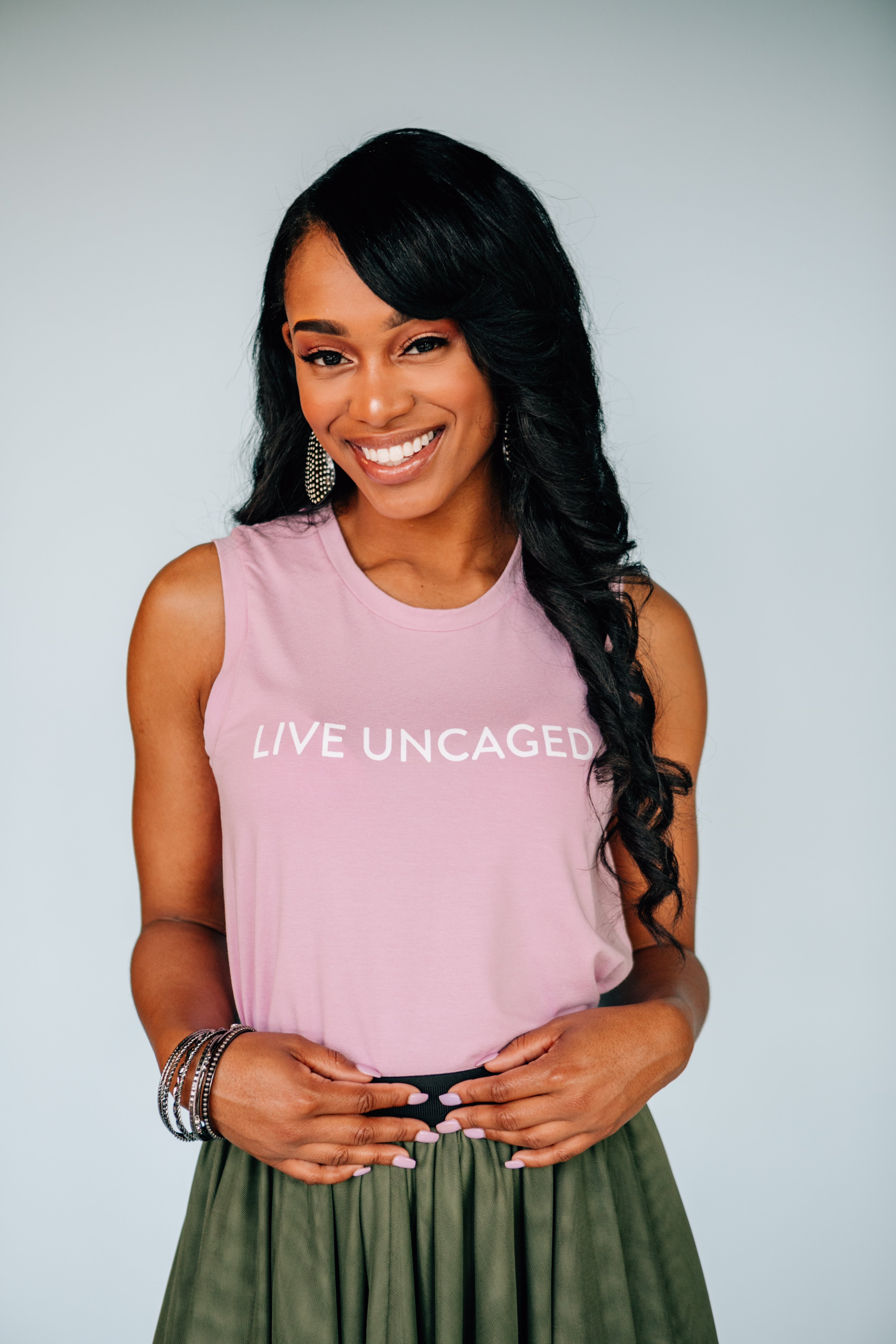 LIVE UNCAGED Tank in Spiced Coral, showcasing its relaxed fit and soft fabric, perfect for casual or office wear.