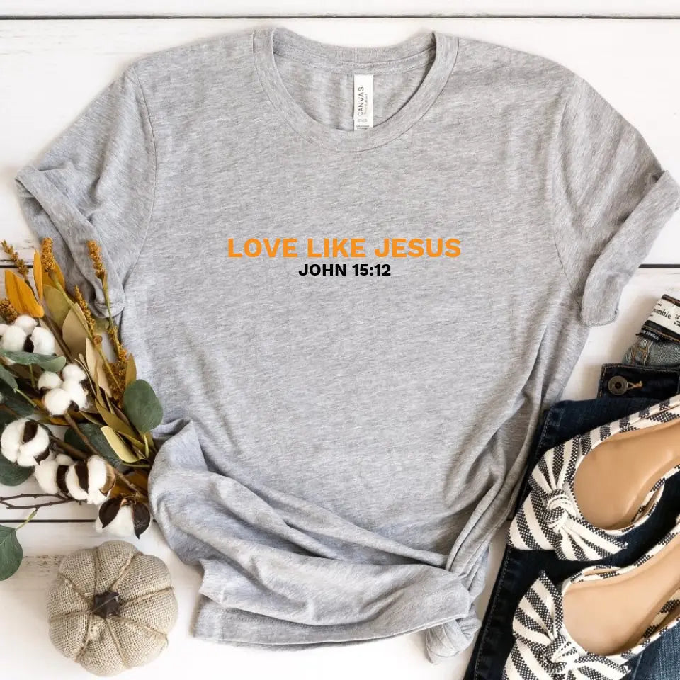 A stylish unisex t-shirt featuring the phrase 'Love Like Jesus' in a modern design, made from soft Ringspun Cotton.