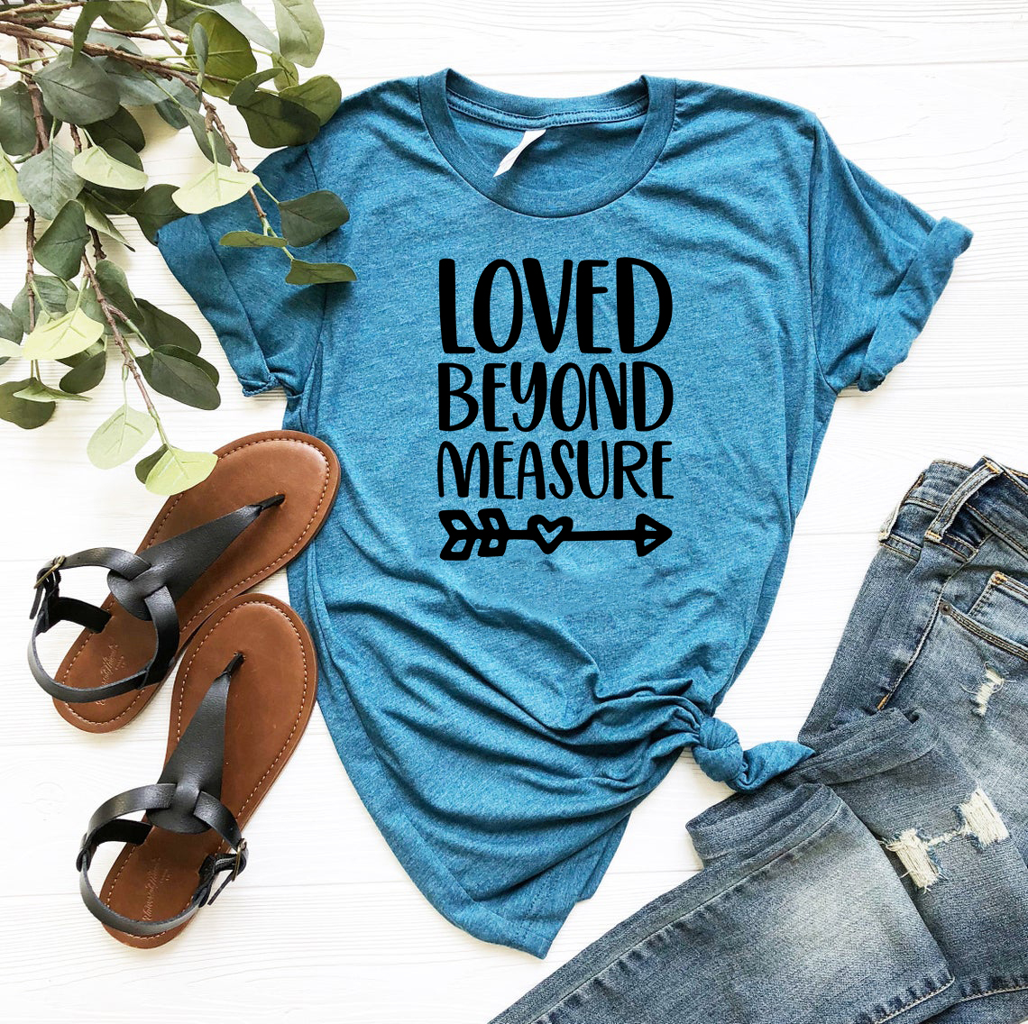 A unisex Loved Beyond Measure Shirt in various colors, showcasing its soft fabric and stylish design.