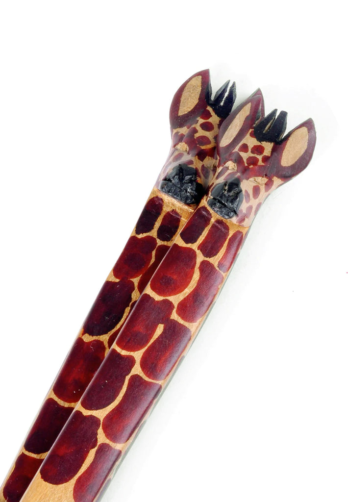 Hand-carved mahogany salad servers featuring whimsical giraffe handles, perfect for serving salads.