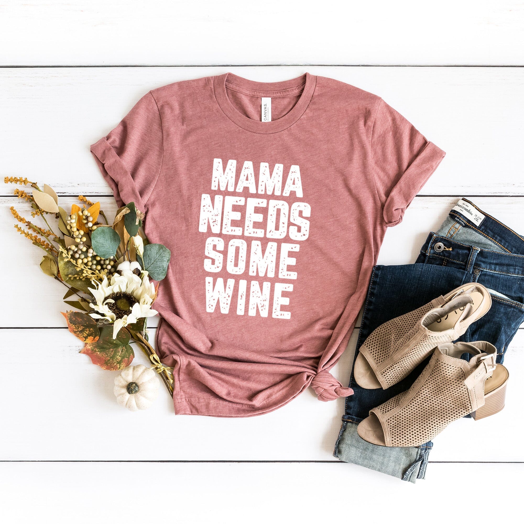 A stylish Mama Needs Some Wine Tee featuring a humorous design, made from soft Ringspun Cotton, perfect for casual wear.