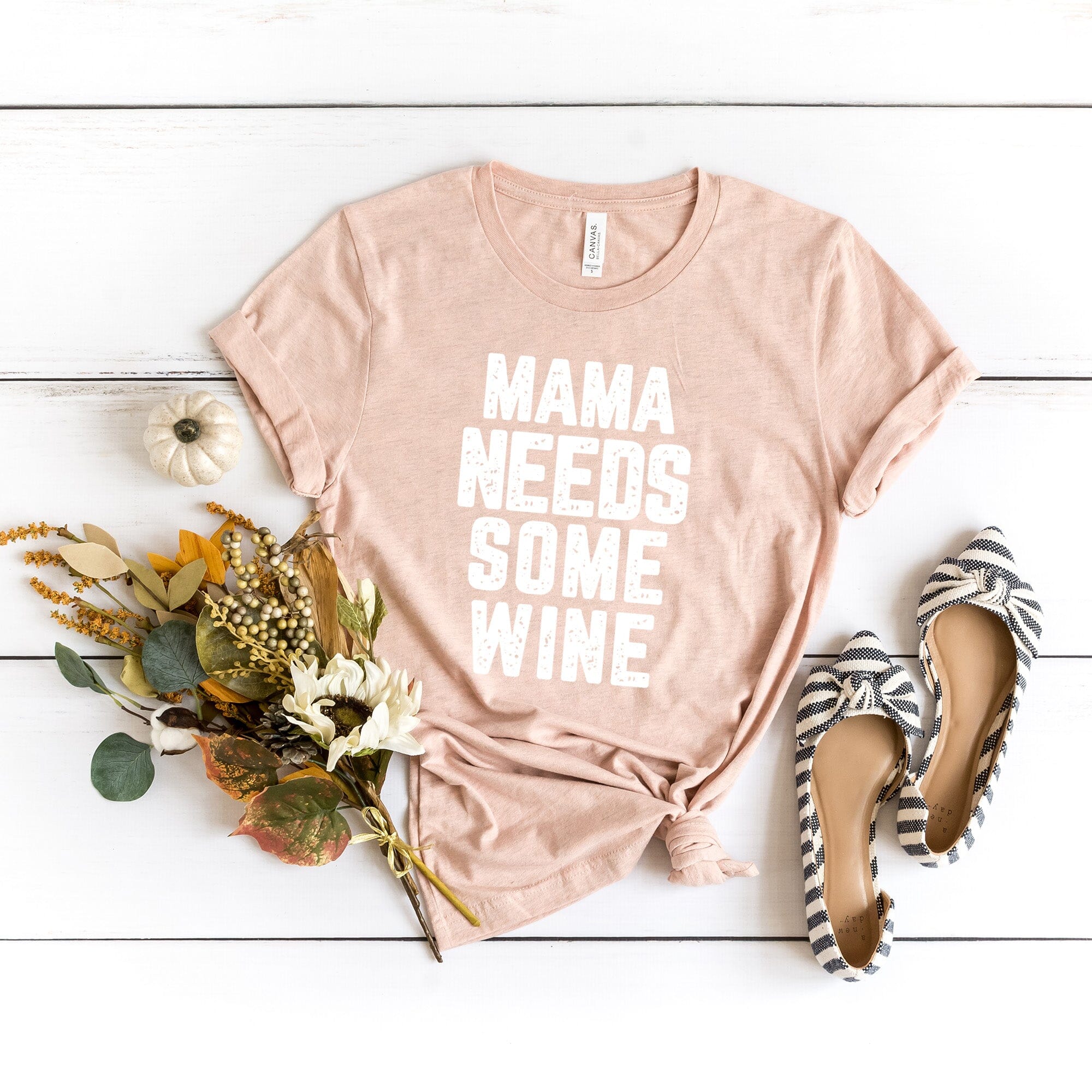 A stylish Mama Needs Some Wine Tee featuring a humorous design, made from soft Ringspun Cotton, perfect for casual wear.