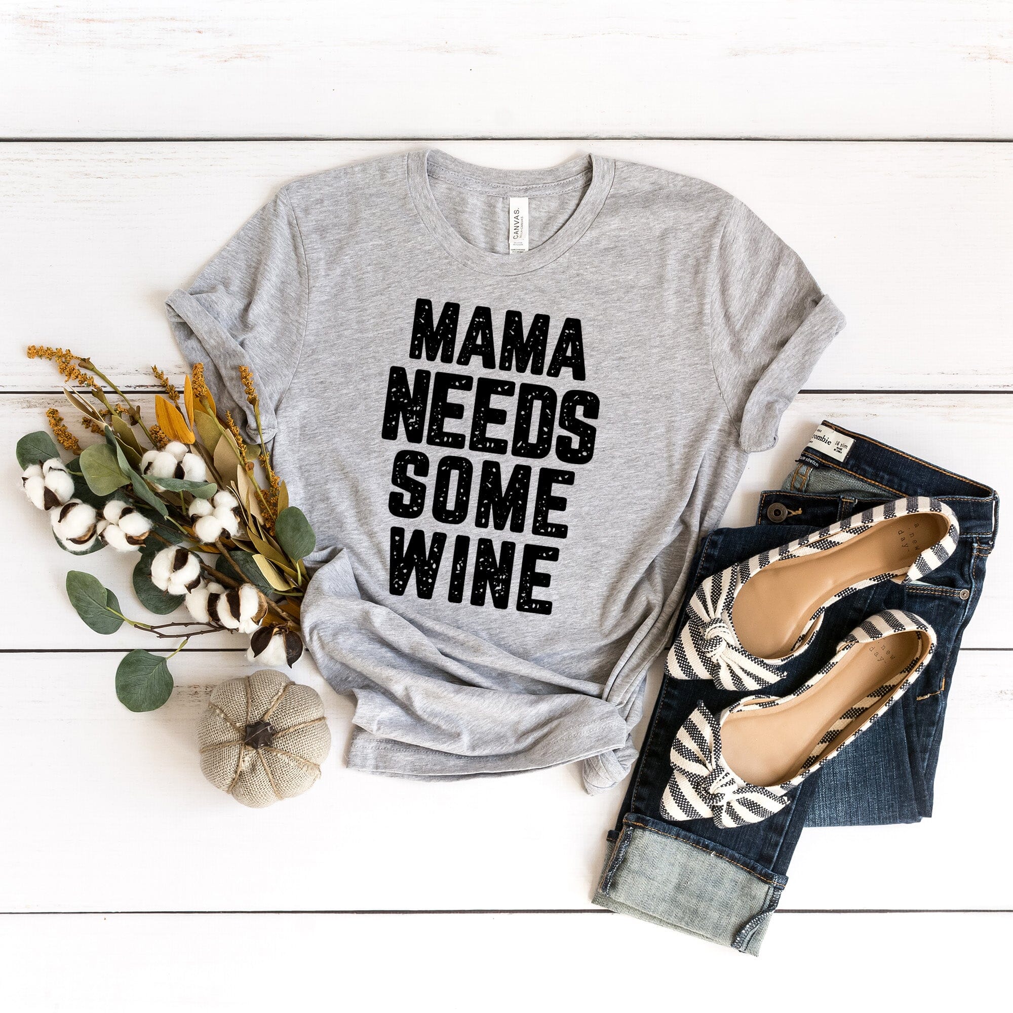 A stylish Mama Needs Some Wine Tee featuring a humorous design, made from soft Ringspun Cotton, perfect for casual wear.