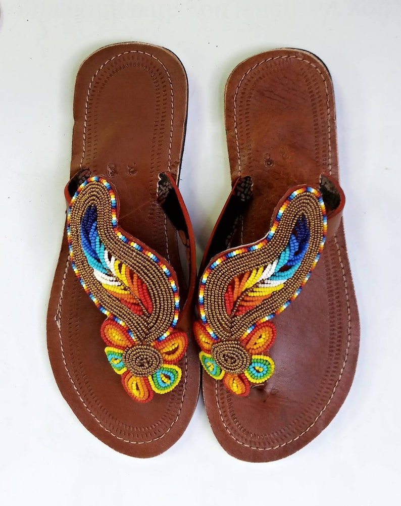 A pair of Maasai Craft Leather Sandals featuring vibrant African beadwork and durable leather, showcasing traditional craftsmanship.