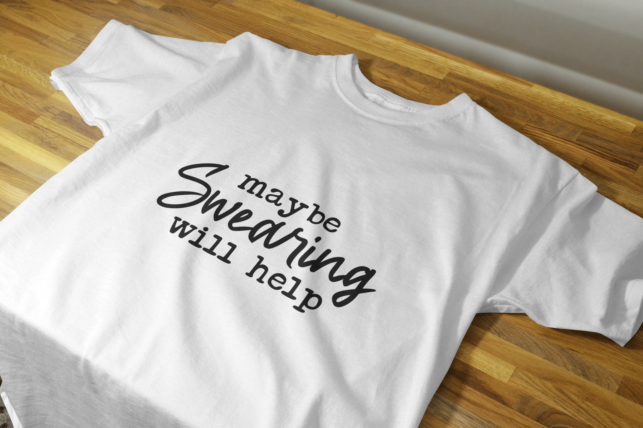 Maybe Swearing Will Help Shirt featuring white lettering on a black Gildan branded unisex shirt, showcasing its classic fit and comfortable design.