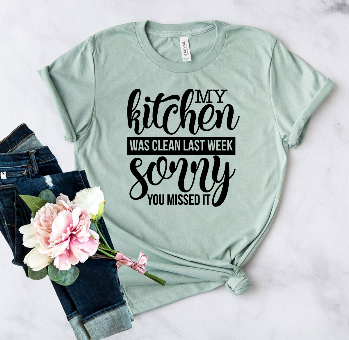 Unisex T-shirt featuring the phrase 'My Kitchen Was Clean Last Week Sorry' in a stylish design, made from soft ring spun cotton.