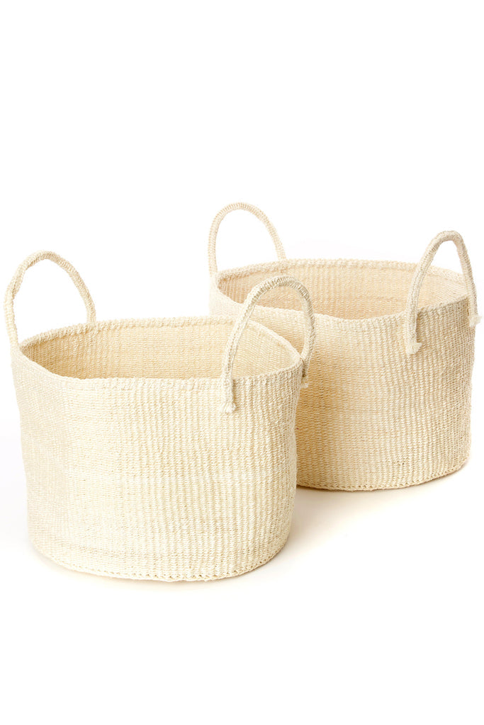 Handwoven natural sisal and fibre African floor storage baskets in cream color, showcasing their unique handcrafted design and durability.