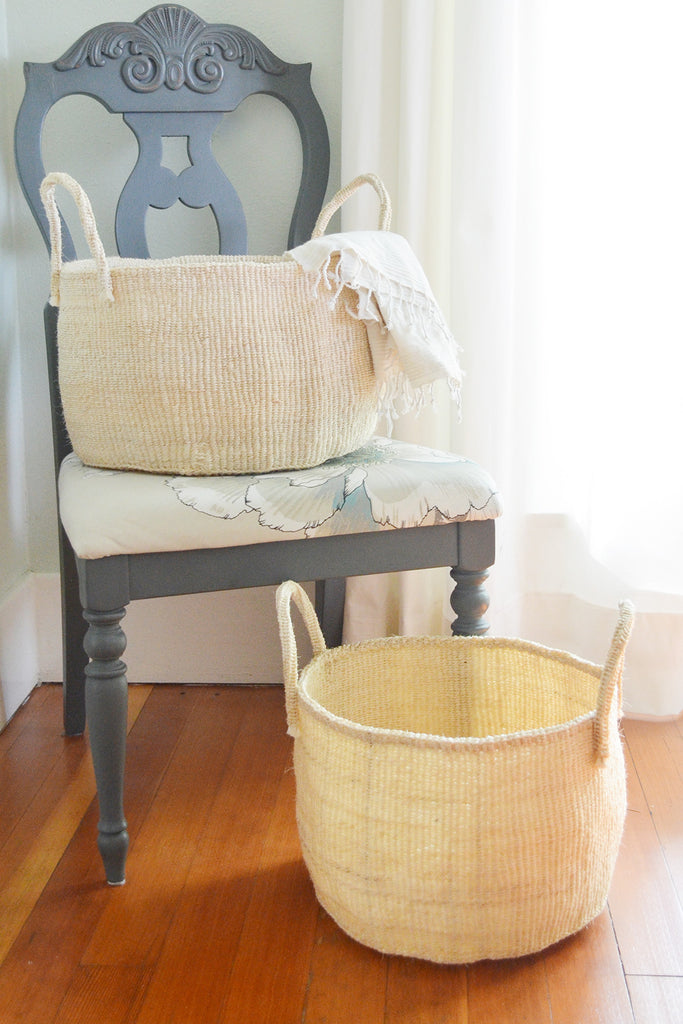 Handwoven natural sisal and fibre African floor storage baskets in cream color, showcasing their unique handcrafted design and durability.