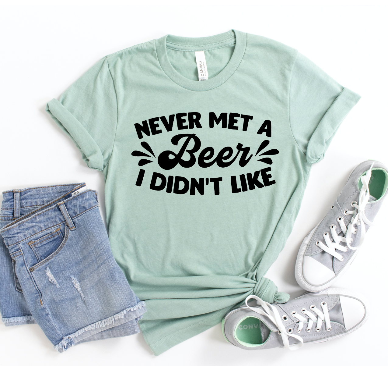 A classic unisex t-shirt featuring the phrase 'Never Met A Beer I Don't Like' printed on it, made from soft cotton fabric.