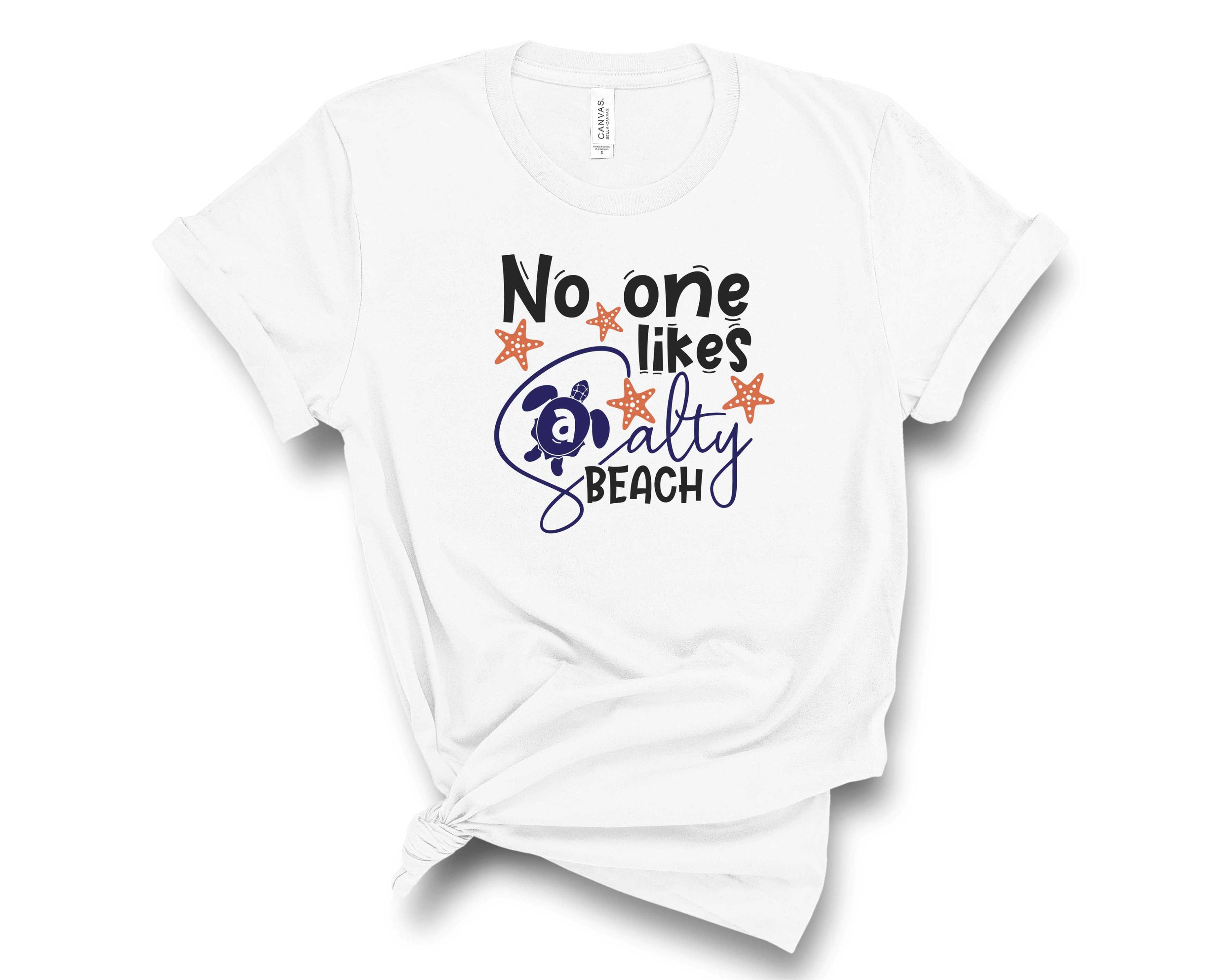 A unisex graphic tee featuring the phrase 'No One Likes a Salty Beach' in a fun font, perfect for casual wear.