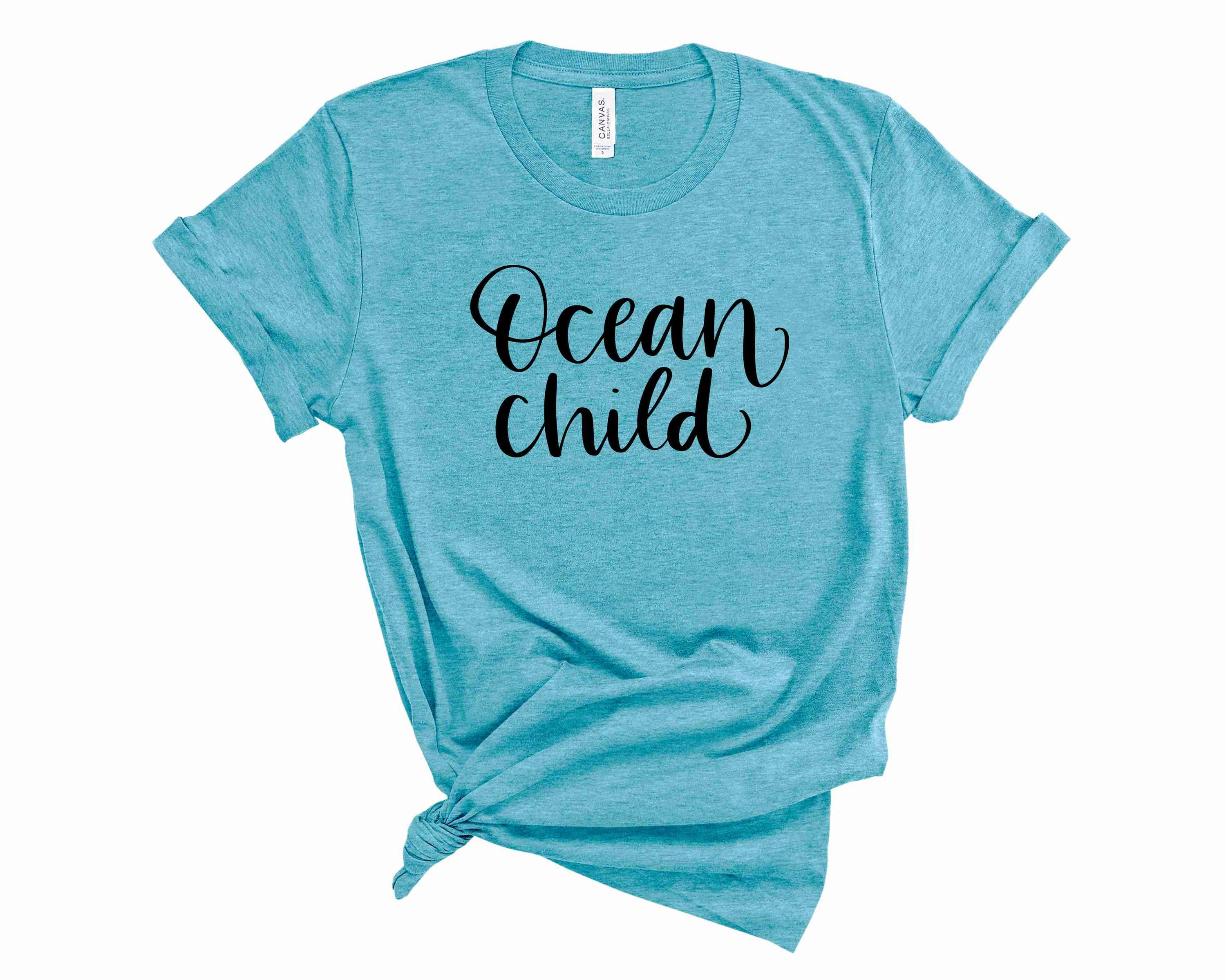 Ocean Child Graphic Tee featuring a vibrant ocean-themed design on a soft unisex t-shirt.