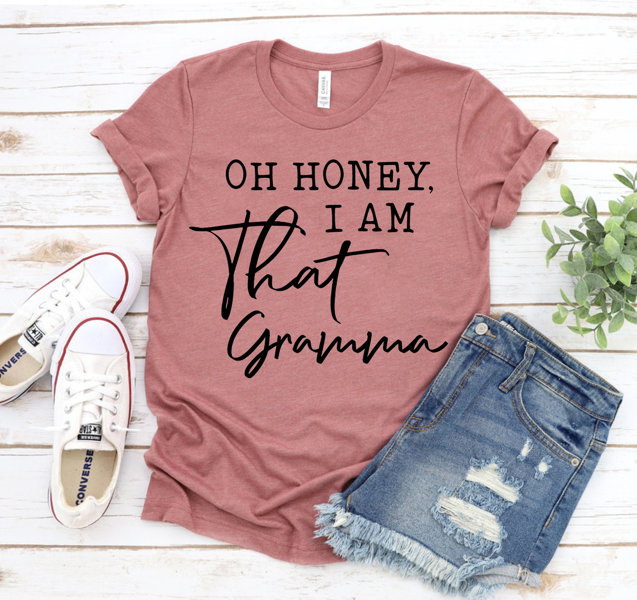 A stylish unisex t-shirt featuring the phrase 'Oh Honey I Am That Gramma' in a playful font, made from soft cotton fabric.