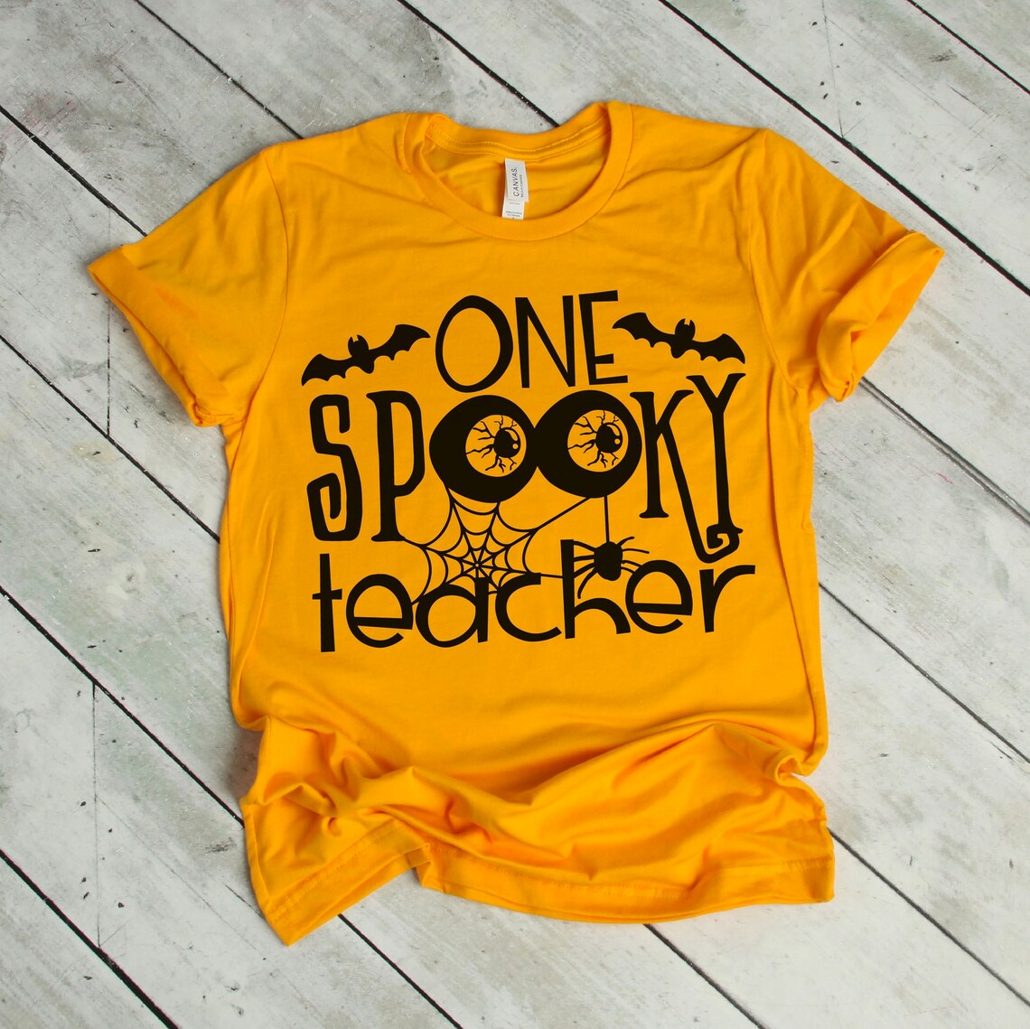 One Spooky Teacher Halloween T-shirt made of premium ring spun cotton with a fun Halloween design.