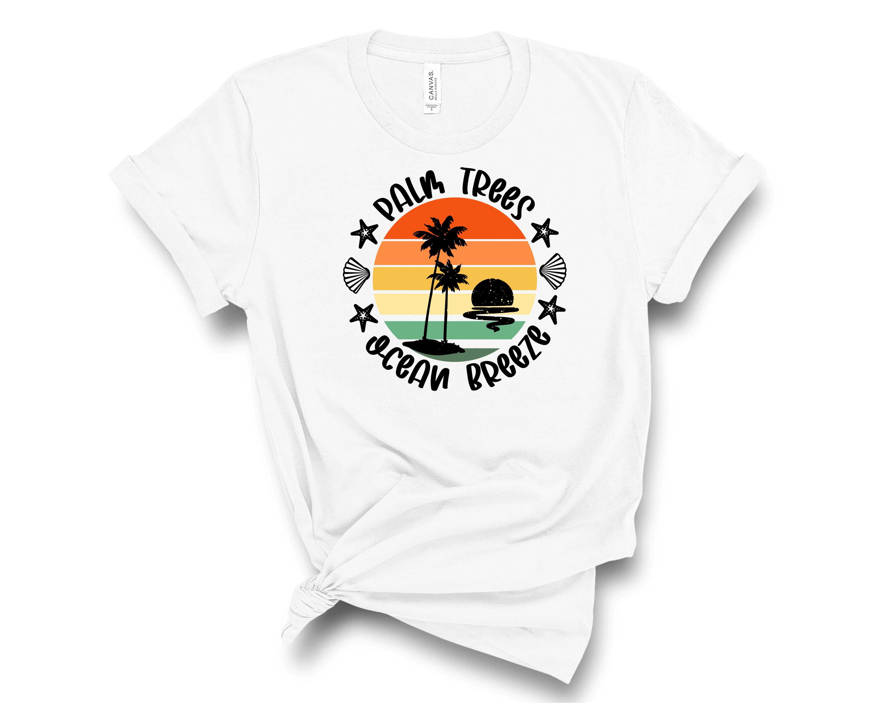 A vibrant unisex graphic tee featuring palm trees and ocean breeze design, perfect for casual wear.