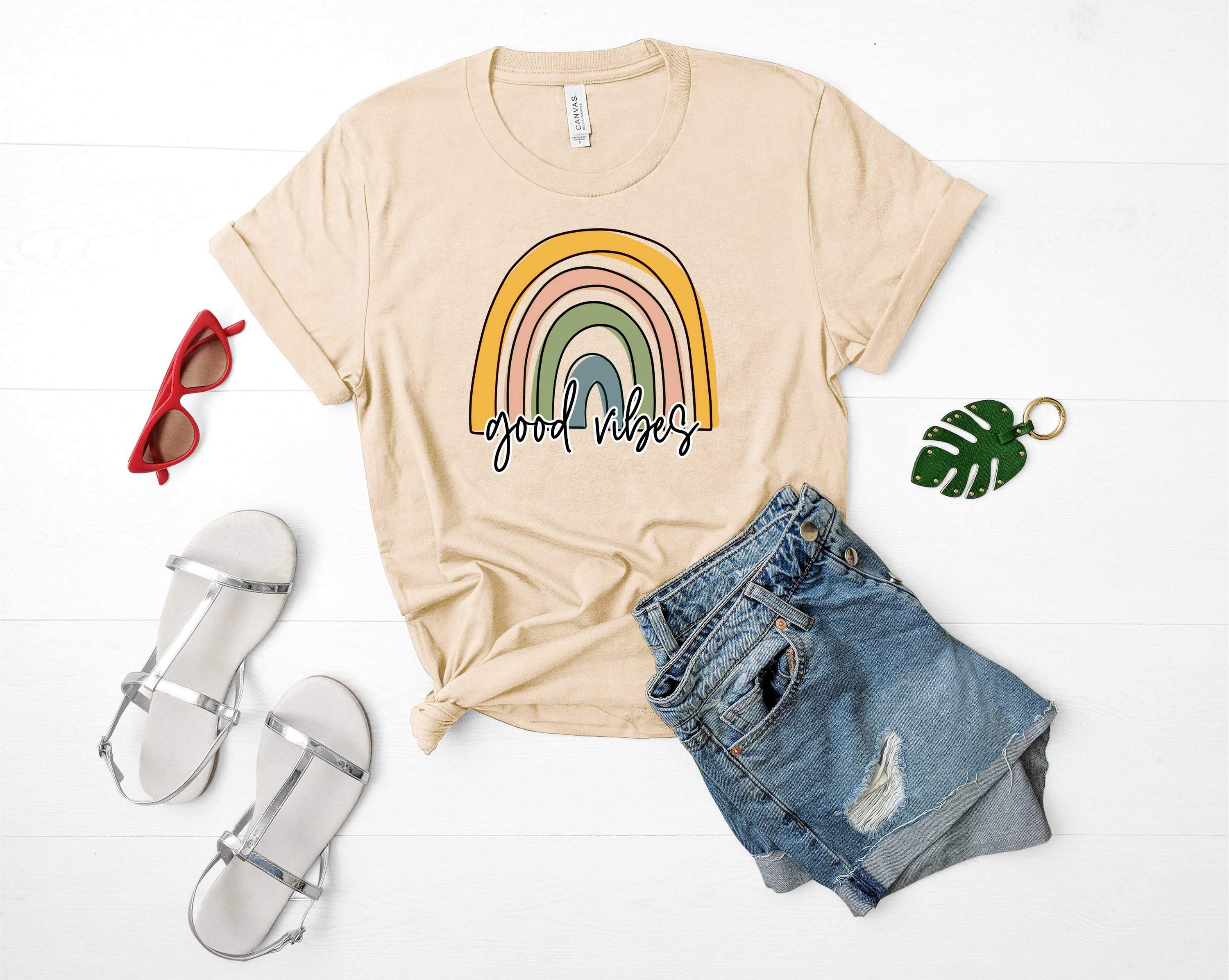 Pastel Rainbow Good Vibes Graphic Tee featuring vibrant colors and a unisex design, perfect for casual wear.