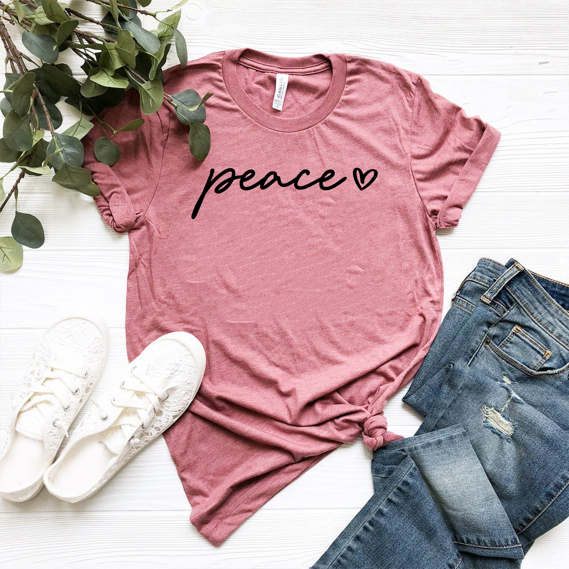 A unisex Peace Shirt made from soft ring spun cotton, available in multiple colors and sizes, featuring a classic crew neck and short sleeves.