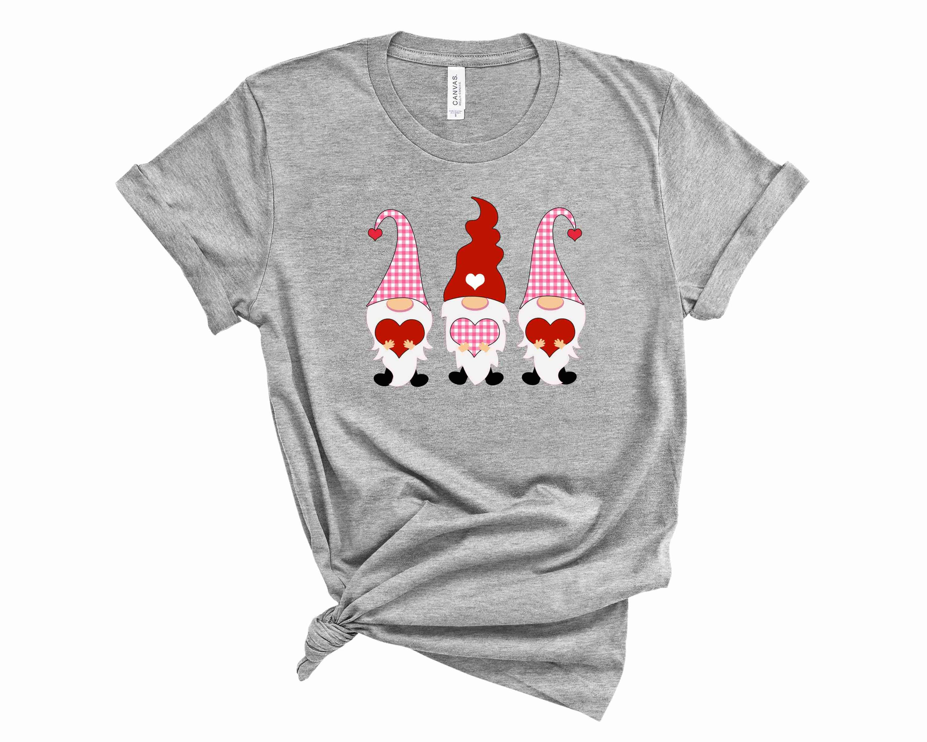 A vibrant pink and red graphic tee featuring whimsical gnome illustrations, perfect for casual wear.