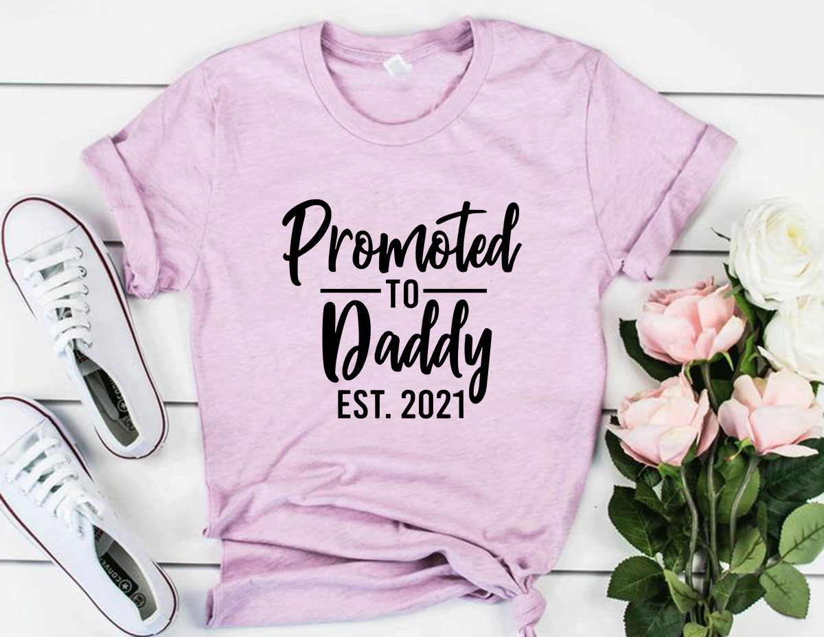 Promoted To Daddy Shirt in various colors, showcasing its soft fabric and stylish design.