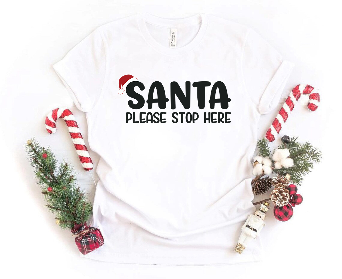 A festive unisex Santa Please Stop Here Shirt made from soft ring spun cotton, featuring a vibrant holiday design.