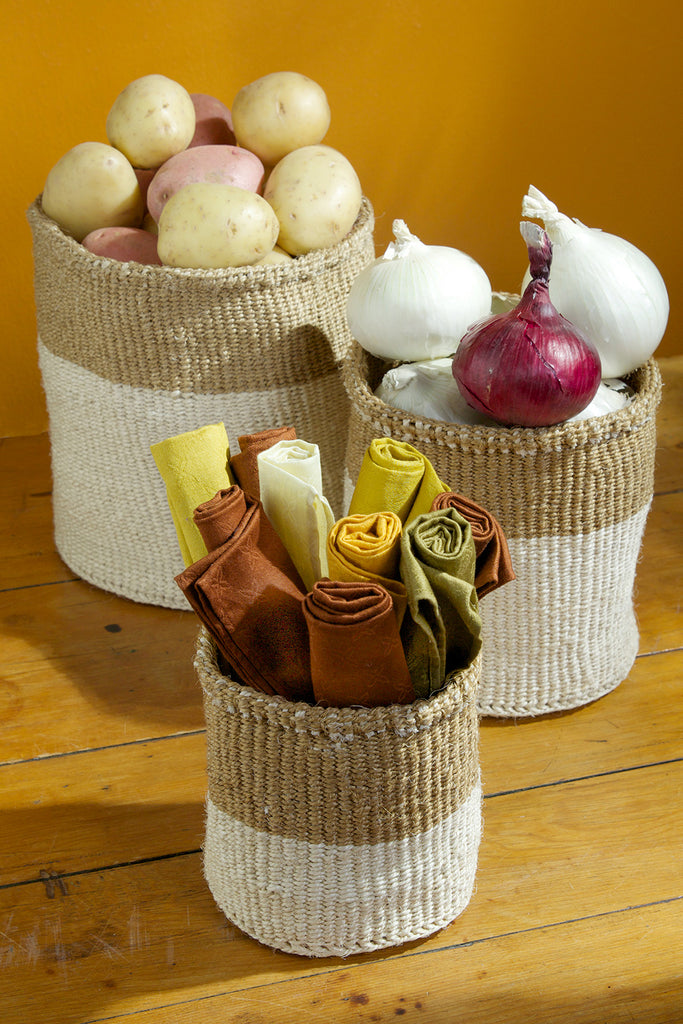 A set of three handwoven sisal baskets in various sizes, showcasing vibrant colors and intricate patterns, perfect for storage or as planters.